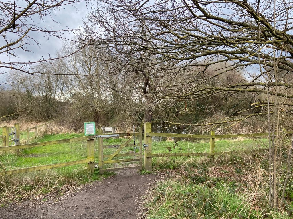 Pass fenced off pond on the right