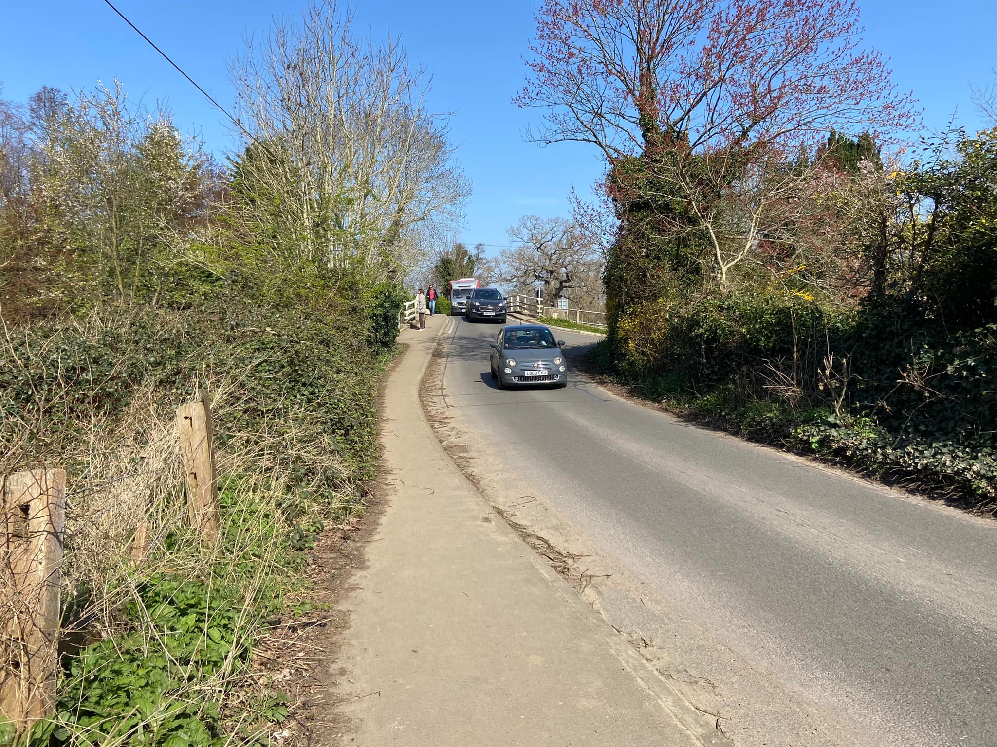 Walk along the pavement and over the bridge
